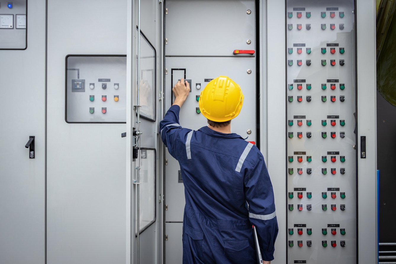 Electrical engineer working in control room. Electrical engineer