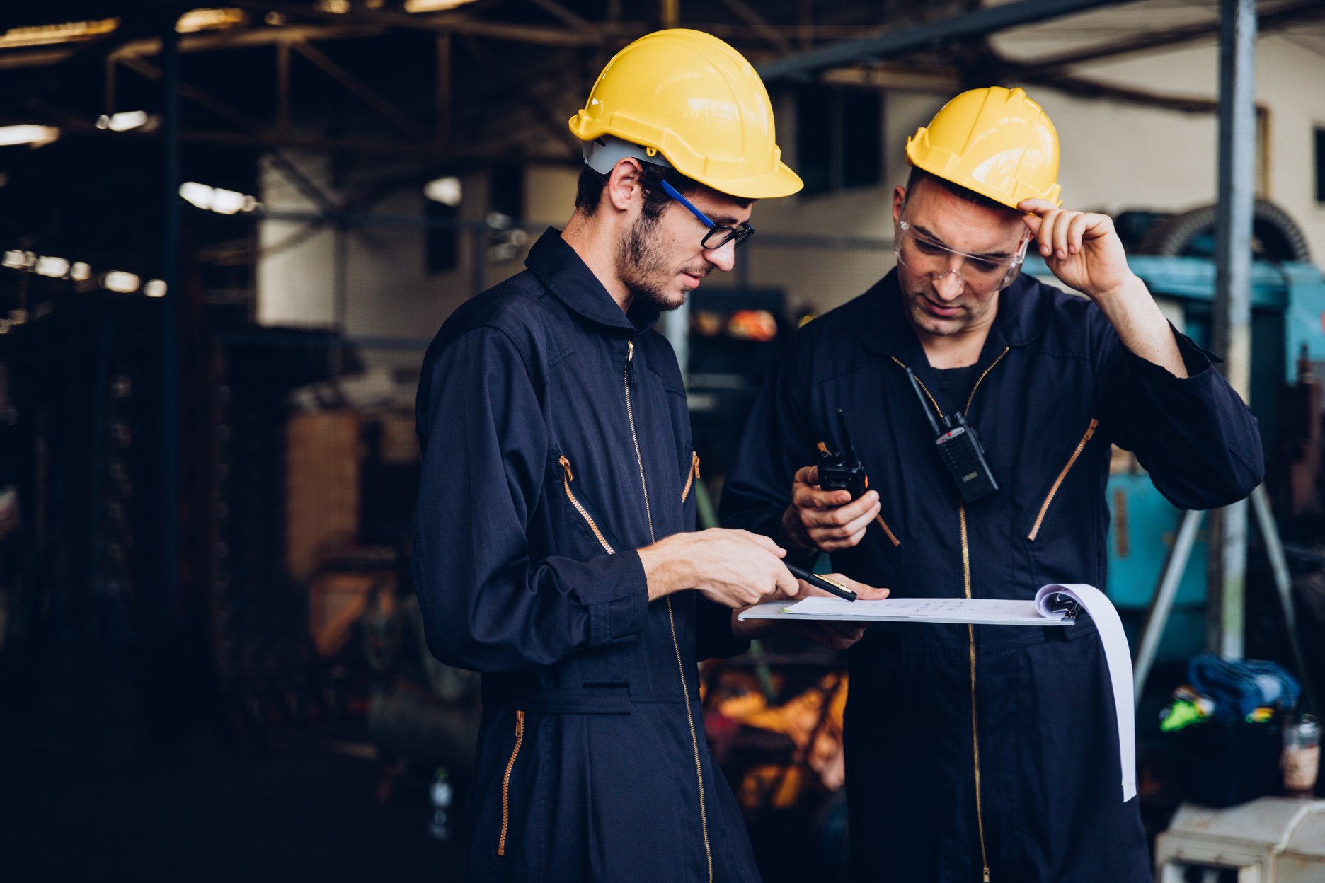 Industrial factory maintenance engineers inspect relay protection system using walkie talkie with copy space for your text. Industry, Maintenance, Engineering and construction concept.